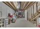 Spacious unfinished basement space, with exposed ceiling beams and shelves for storage at 1202 Vestman Ct, Greenwood, IN 46143