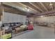 This unfinished basement features exposed ductwork and a seating area with a sofa and table at 1202 Vestman Ct, Greenwood, IN 46143
