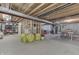 Open unfinished basement space with exposed beams, storage, and a ping pong table at 1202 Vestman Ct, Greenwood, IN 46143