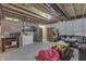 This unfinished basement features a seating area, a refrigerator, and a ping pong table at 1202 Vestman Ct, Greenwood, IN 46143