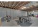 This unfinished basement features a ping pong table and unfinished walls at 1202 Vestman Ct, Greenwood, IN 46143