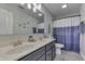 This bathroom features a double vanity and a shower with a blue and white curtain at 1202 Vestman Ct, Greenwood, IN 46143