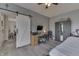Bedroom with a sliding barn door and a study area including a desk, chair, and storage at 1202 Vestman Ct, Greenwood, IN 46143