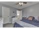 This bedroom features gray walls, a ceiling fan, and a bed with a navy blue comforter at 1202 Vestman Ct, Greenwood, IN 46143