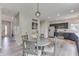 Neutral dining area with decoratively carved chairs and an open concept floor plan at 1202 Vestman Ct, Greenwood, IN 46143