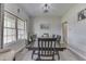 Elegant dining room featuring a large wooden table, seating for eight, and bright natural light at 1202 Vestman Ct, Greenwood, IN 46143