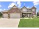 Charming two-story home featuring brick accents, a well-manicured lawn, and an attached two-car garage at 1202 Vestman Ct, Greenwood, IN 46143