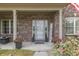 Inviting front porch with decorative plants and patriotic accents around the doorway at 1202 Vestman Ct, Greenwood, IN 46143