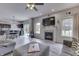 Bright living room with a fireplace, large TV, and sliding doors to the backyard at 1202 Vestman Ct, Greenwood, IN 46143