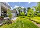 Lush backyard featuring a large patio, beautiful landscaping, and mature trees at 12022 Otto Ln, Carmel, IN 46032