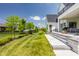 Well-manicured backyard featuring a large patio and lush green lawn with beautiful landscaping at 12022 Otto Ln, Carmel, IN 46032