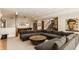 Spacious finished basement with a gray sectional sofa, pool table, and staircase leading to the upper level at 12022 Otto Ln, Carmel, IN 46032