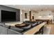 Finished basement featuring a gray sectional sofa, pool table, and a bar area with stylish pendant lighting at 12022 Otto Ln, Carmel, IN 46032
