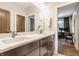Contemporary bathroom with dual sinks, ample counter space, and a view into the adjacent office space at 12022 Otto Ln, Carmel, IN 46032