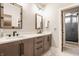 Elegant bathroom with double sinks, modern fixtures, a large mirror, and a separate shower room for added privacy at 12022 Otto Ln, Carmel, IN 46032