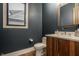 Modern powder room featuring a sleek vanity, designer mirror, and stylish finishes at 12022 Otto Ln, Carmel, IN 46032