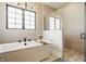 Modern bathroom with sleek soaking tub and glass enclosed shower at 12022 Otto Ln, Carmel, IN 46032