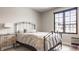 Cozy bedroom featuring a decorative metal bed frame and a large window at 12022 Otto Ln, Carmel, IN 46032