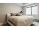 Cozy bedroom with neutral tones, comfortable bed, and a large window offering plenty of natural light at 12022 Otto Ln, Carmel, IN 46032