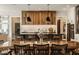 Bright dining room highlighting a wooden table with seating for ten and views into the modern kitchen at 12022 Otto Ln, Carmel, IN 46032