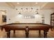 Game room features a classic wood pool table with pendant lighting and seating at 12022 Otto Ln, Carmel, IN 46032