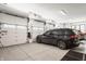 Well-lit garage featuring epoxy flooring, electric car charger, and multiple bays at 12022 Otto Ln, Carmel, IN 46032