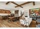 Open-concept great room boasts wood beams, hardwood floors, and seamless flow between living, dining, and kitchen spaces at 12022 Otto Ln, Carmel, IN 46032