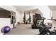 Well-equipped home gym with treadmills, weightlifting equipment, and large mirror at 12022 Otto Ln, Carmel, IN 46032