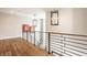 Bright hallway featuring hardwood floors, modern railings, and stylish light fixtures, creating an inviting space at 12022 Otto Ln, Carmel, IN 46032