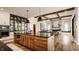 Open-concept kitchen connected to the living room, featuring modern appliances, a large island, and sleek countertops at 12022 Otto Ln, Carmel, IN 46032