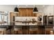 Contemporary kitchen featuring a large island with bar seating, modern fixtures, and a view to the living room at 12022 Otto Ln, Carmel, IN 46032