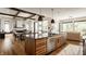 Well-designed kitchen boasts a large island, seamless flow to the living area, and custom wood cabinetry at 12022 Otto Ln, Carmel, IN 46032