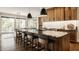 Stylish kitchen island with pendant lights, stainless steel appliances, and an open view to the living area at 12022 Otto Ln, Carmel, IN 46032