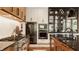 Contemporary kitchen with stainless steel appliances, wood and white cabinets, and an island with a sink and dishwasher at 12022 Otto Ln, Carmel, IN 46032