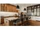 Spacious kitchen with dark countertops, custom wood cabinets, stainless steel appliances and open to the dining area at 12022 Otto Ln, Carmel, IN 46032