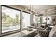 Bright living room with modern lighting, large windows and comfortable seating at 12022 Otto Ln, Carmel, IN 46032
