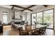Elegant living room with stone fireplace, beamed ceiling, and sliding doors to the outdoor space at 12022 Otto Ln, Carmel, IN 46032