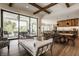 Open-concept living space with wood floors, beamed ceiling, and sliding glass doors to the patio at 12022 Otto Ln, Carmel, IN 46032