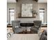 Cozy living room featuring a modern fireplace, patterned chairs, and large windows with cushioned seats at 12022 Otto Ln, Carmel, IN 46032