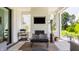 Relaxing outdoor space with an outdoor fireplace, television, and comfortable seating, great for entertaining at 12022 Otto Ln, Carmel, IN 46032