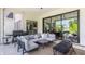 Stylish covered patio with a comfortable seating area, grill, and sliding glass doors for indoor/outdoor living at 12022 Otto Ln, Carmel, IN 46032