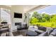 Inviting outdoor patio with fireplace, TV, and comfortable seating area at 12022 Otto Ln, Carmel, IN 46032