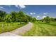 Picturesque walking path winding through a lush green landscape, perfect for a stroll or jog in nature at 12022 Otto Ln, Carmel, IN 46032