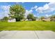 Large backyard with a lush green lawn and several storage sheds at 124 Bess Blvd, Pendleton, IN 46064