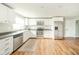 Bright, modern kitchen features stainless steel appliances, white cabinets, and wood flooring at 124 Bess Blvd, Pendleton, IN 46064