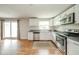A modern kitchen boasts stainless steel appliances, wood floors, and a slider to the outdoors at 124 Bess Blvd, Pendleton, IN 46064
