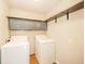 The laundry room features a washer, dryer, overhead cabinets, and shelf for storage at 124 Bess Blvd, Pendleton, IN 46064