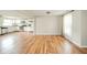 Open-concept space featuring white cabinets, stainless appliances, and wood floors. Kitchen adjacent at 124 Bess Blvd, Pendleton, IN 46064