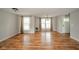 Sun-filled living room with hardwood floors and neutral paint, enhanced by natural light from large windows at 124 Bess Blvd, Pendleton, IN 46064