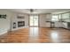 Inviting living room with wood floors, a brick fireplace, and sliding doors leading to the outdoors at 124 Bess Blvd, Pendleton, IN 46064